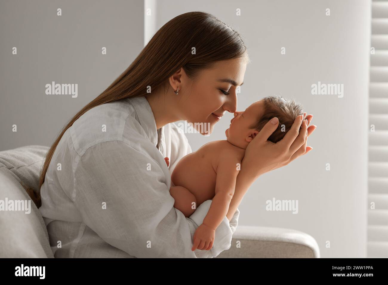 Mère tenant son bébé nouveau-né mignon à l'intérieur Banque D'Images