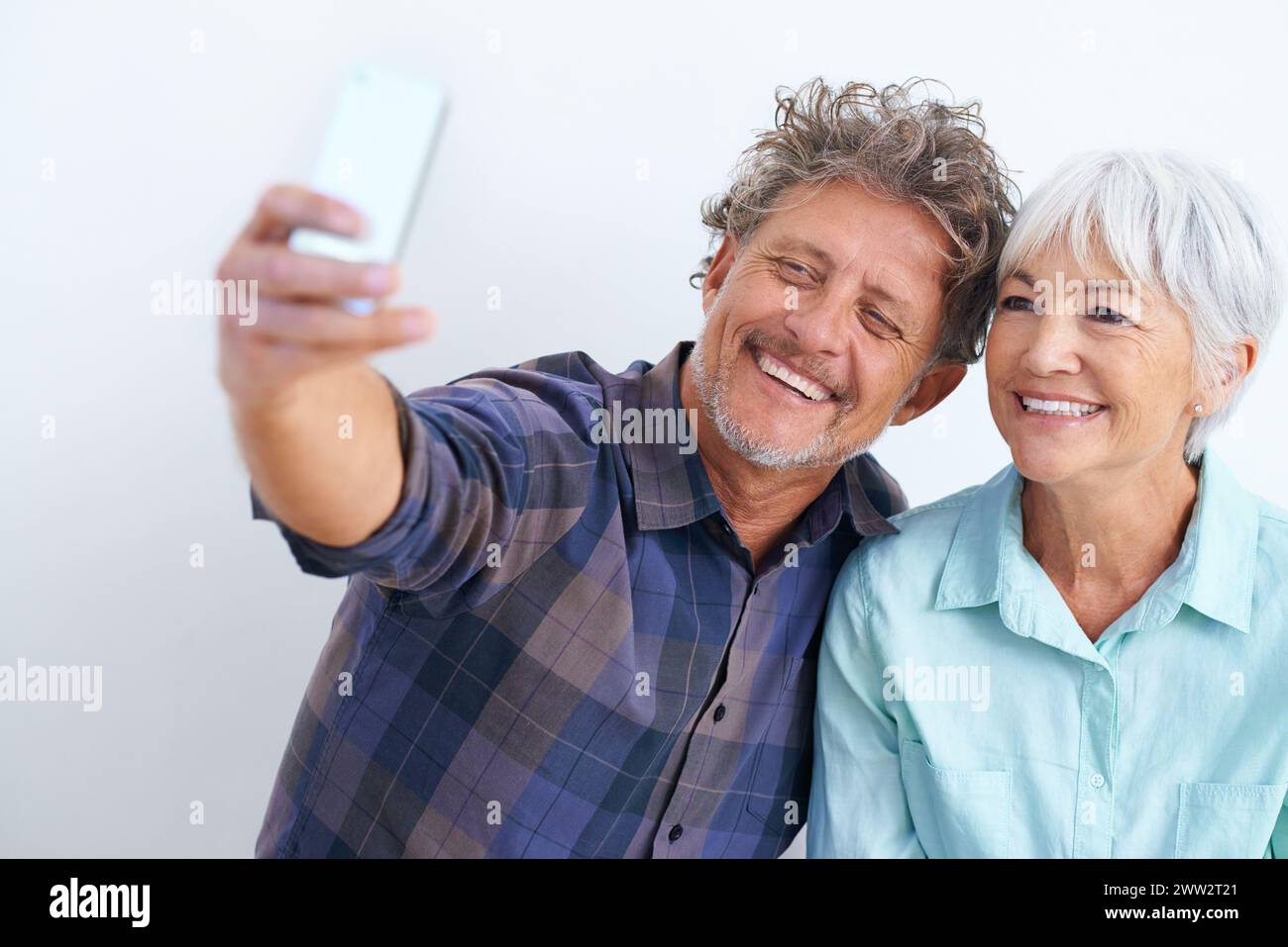 Vieux couple, selfie et heureux ensemble pour les médias sociaux post, la mémoire et l'amour avec joie sur fond blanc. Confiance, soutien et loyauté envers les gens Banque D'Images