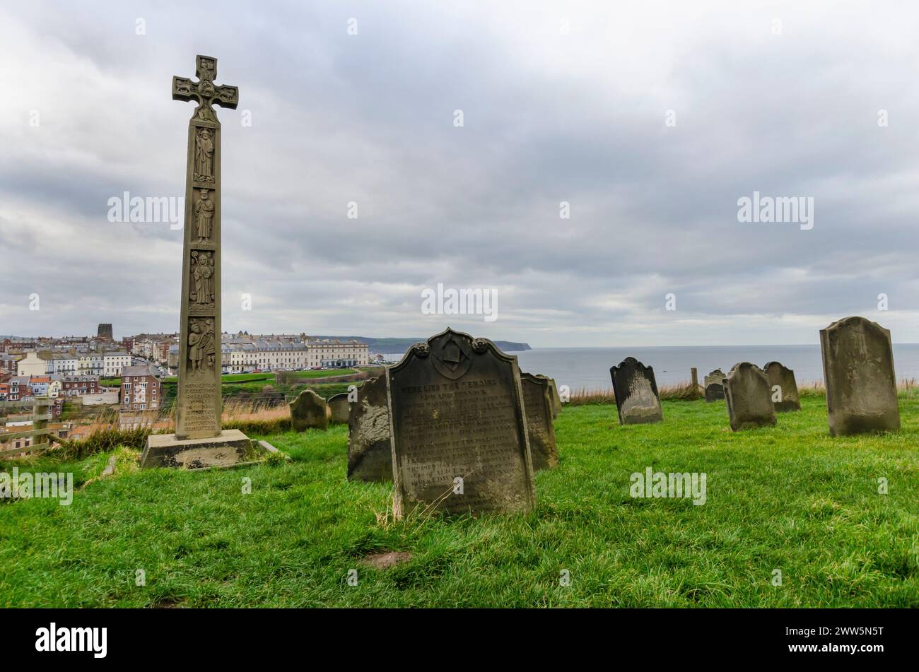 Cette photographie d'ambiance capture le cimetière historique de l'église de Saint Mary à Whitby, en Angleterre, surplombant la mer du Nord. Les vieilles pierres tombales... Banque D'Images