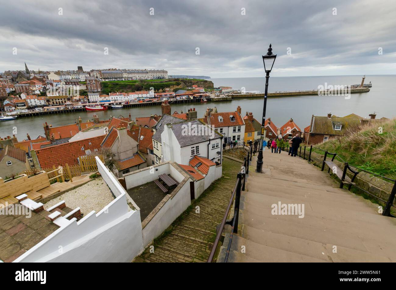 Cette photographie d'ambiance capture le cimetière historique de l'église de Saint Mary à Whitby, en Angleterre, surplombant la mer du Nord. Les vieilles pierres tombales... Banque D'Images