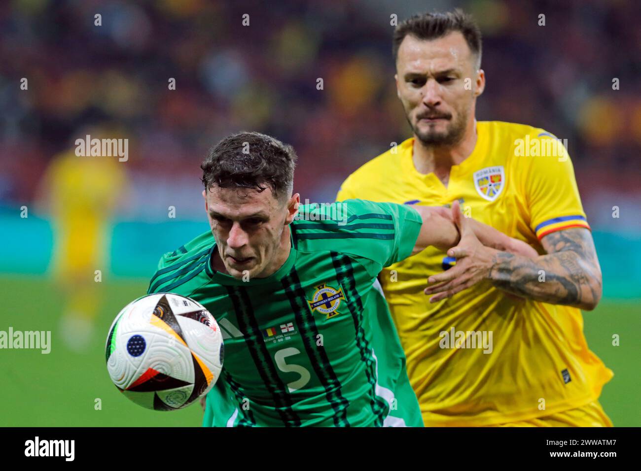 Bucarest, Roumanie. 22 mars 2024. Vasile Mogos (R) de Roumanie affronte Eoin Toal d'Irlande du Nord lors du match international amical de football entre la Roumanie et l'Irlande du Nord à la National Arena de Bucarest, Roumanie, le 22 mars 2024. Crédit : Cristian Cristel/Xinhua/Alamy Live News Banque D'Images