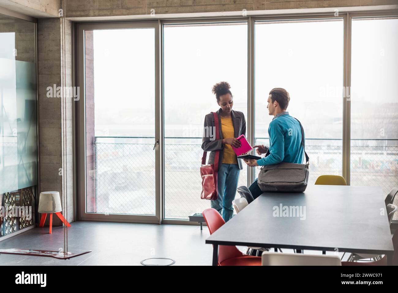 Jeunes collègues d'affaires discutant sur le lieu de travail Banque D'Images