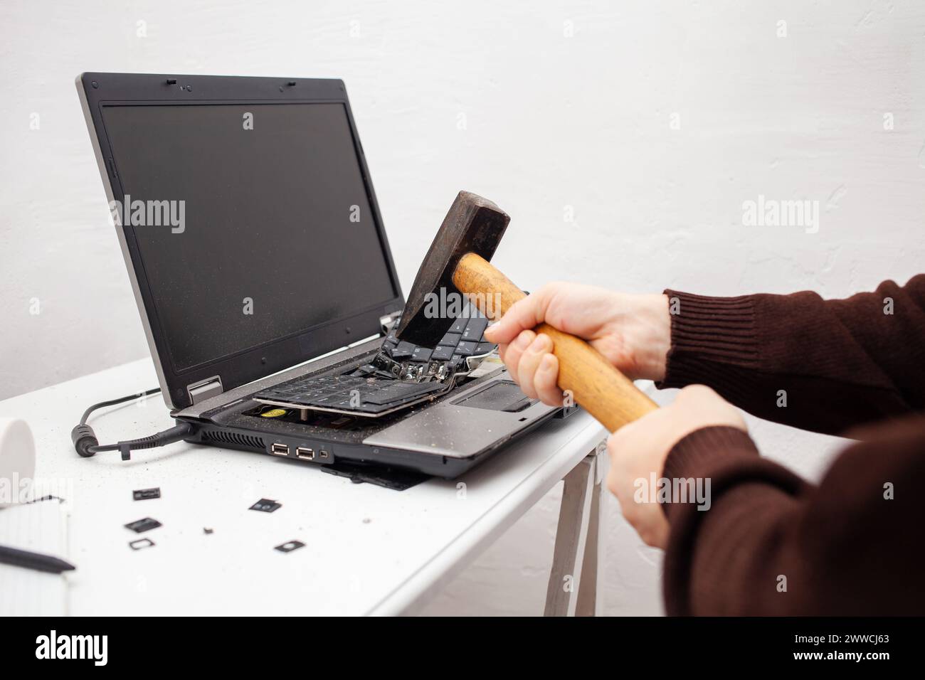 Un employé de bureau a brisé un ordinateur portable, détruit un ordinateur. Colère haine, irritation. Erreur, frein, dysfonctionnement, ne veut pas travailler. Mauvaises émotions. dep Banque D'Images