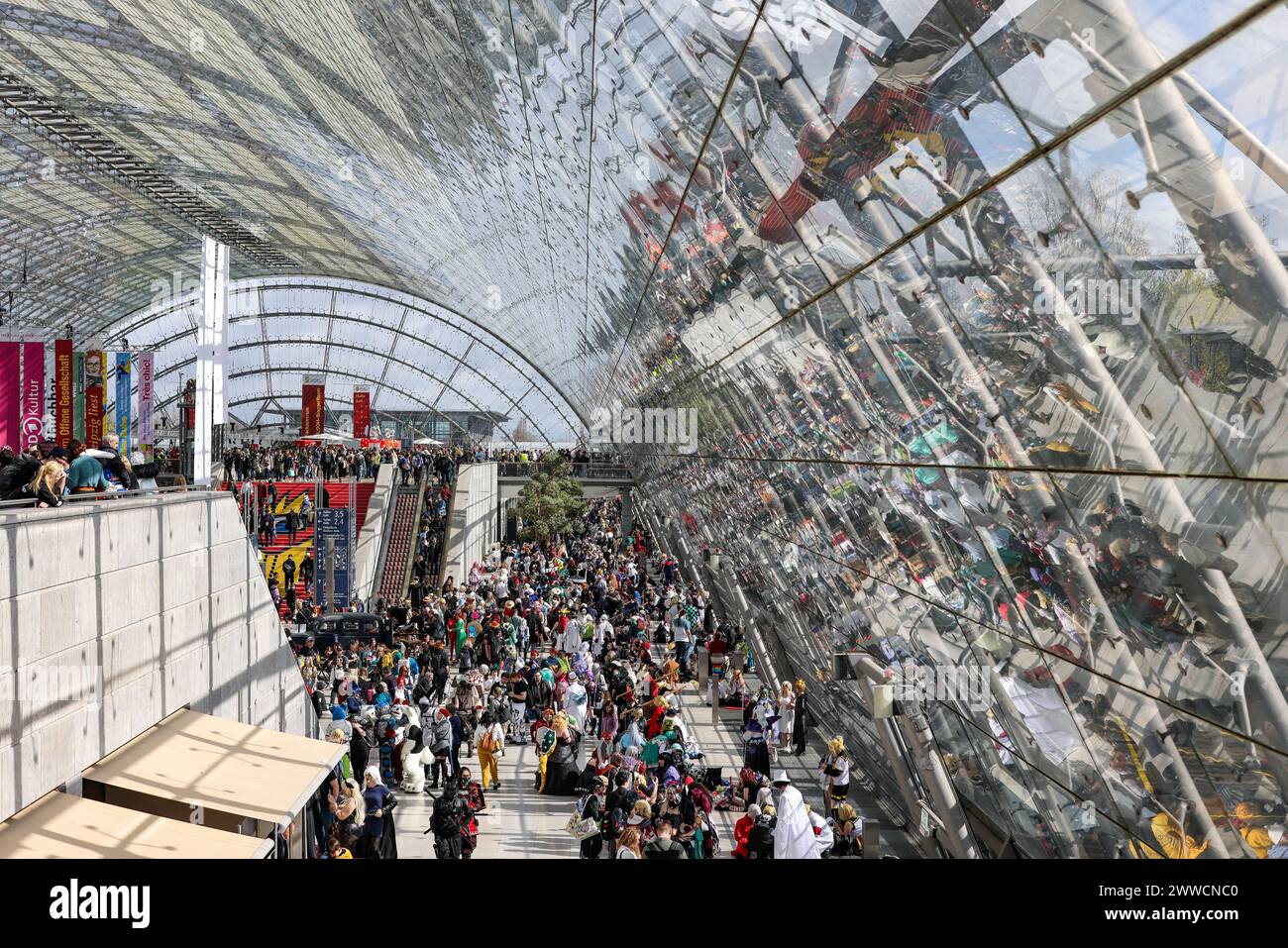 Leipzig, Allemagne. 23 mars 2024. De nombreux visiteurs remplissent la salle de verre de la Foire du livre de Leipzig. Plus de 2000 exposants de 40 pays présentent leurs nouveaux produits à la réunion de printemps de l'industrie du livre. Crédit : Jan Woitas/dpa/Alamy Live News Banque D'Images