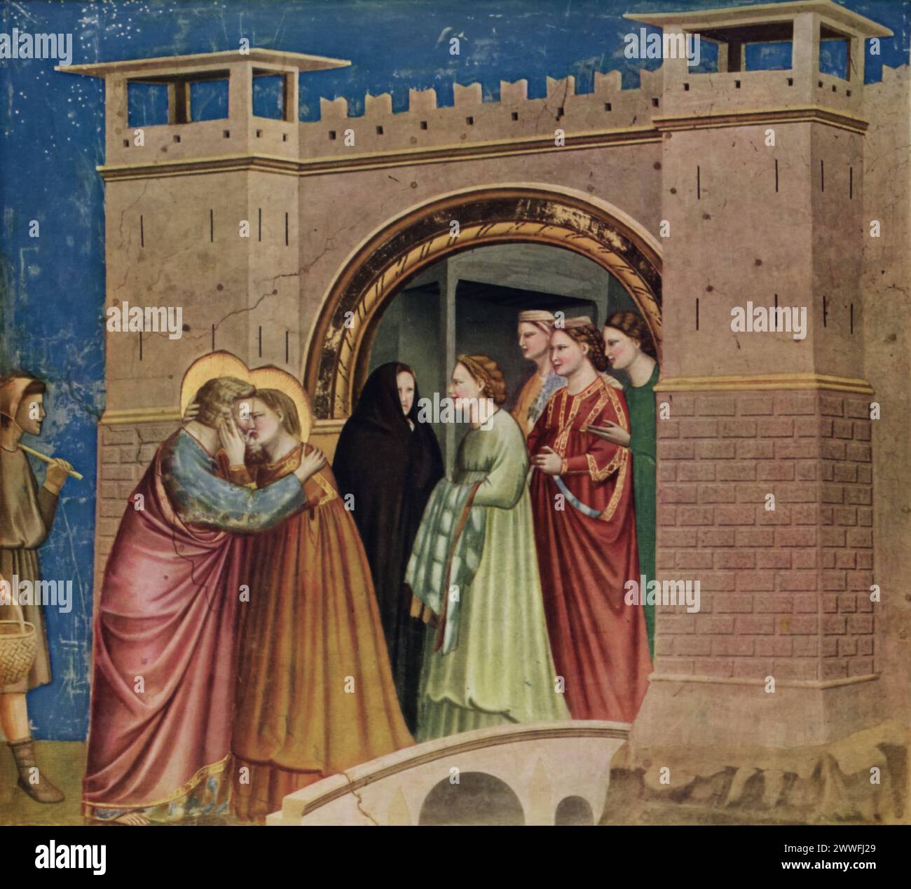 La rencontre de Joachim et Anna de Giotto (début du XIVe siècle) : cette fresque, située dans la chapelle des Scrovegni à Padoue, représente l'étreinte joyeuse de Joachim et Anna à la porte d'Or de Jérusalem, un moment célébré pour sa représentation de la grâce divine et de l'émotion humaine. La maîtrise de Giotto dans la représentation de la profondeur, de l'émotion et des détails architecturaux annonce l'aube de la Renaissance, soulignant la signification spirituelle du récit à travers un réalisme révolutionnaire. Banque D'Images