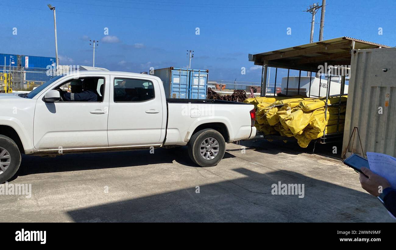 Des membres de la Garde côtière américaine observent l'arrivée de boom lors d'un exercice non annoncé initié par le gouvernement (GIUE) à Mobil Saipan le 29 février 2024, à Saipan, dans le Commonwealth des îles Mariannes du Nord. L'objectif principal d'une GIUE est de s'assurer que le titulaire du plan peut mettre en œuvre efficacement son plan d'intervention dans le cadre d'un scénario d'intervention en milieu marin. Garde-côtes Banque D'Images