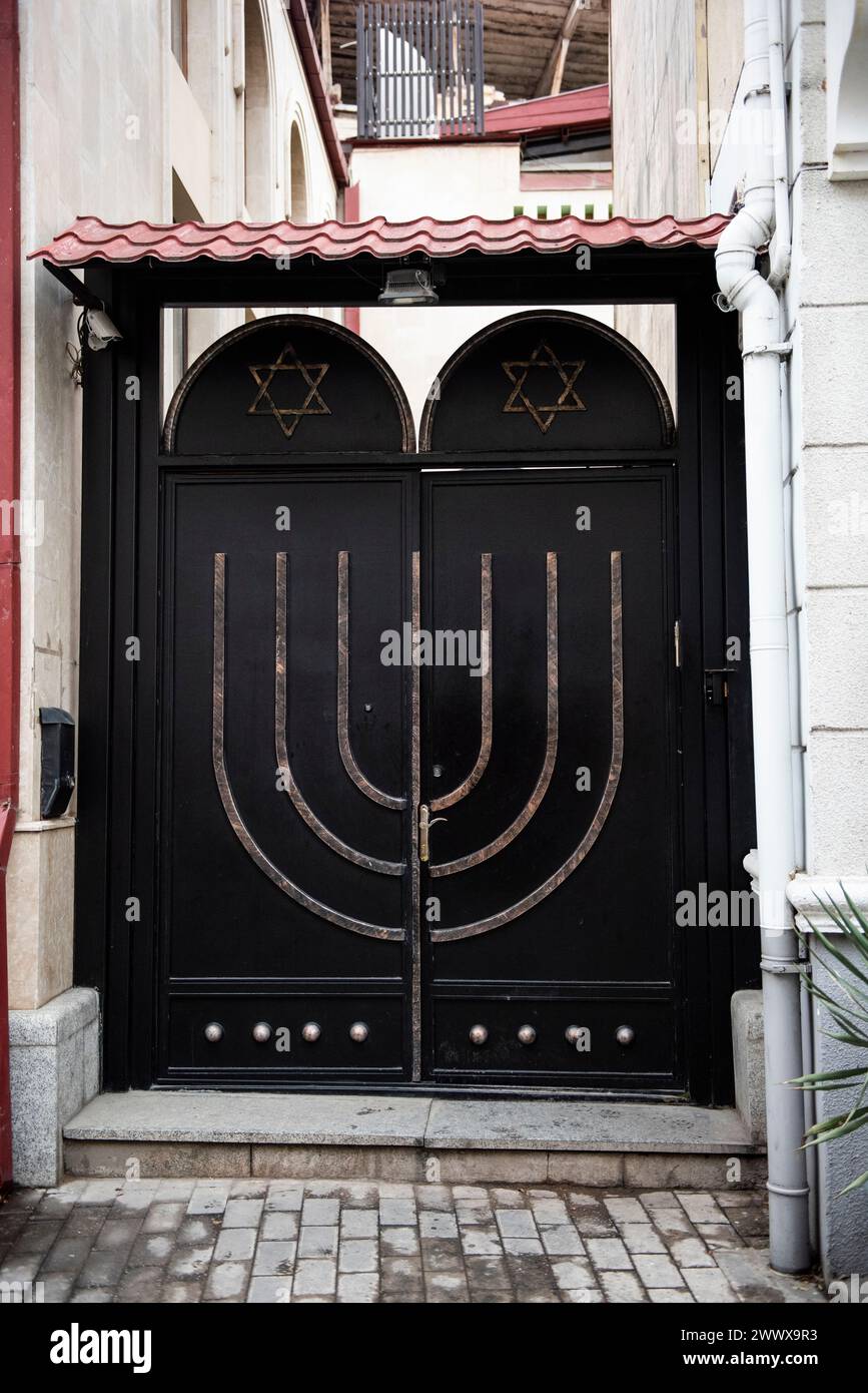 Une porte sécurisée décorée d'une menorah et d'étoiles juives à l'entrée de la synagogue Beit Rachel ou Maison de Rachel à Tbilissi, Géorgie. Banque D'Images