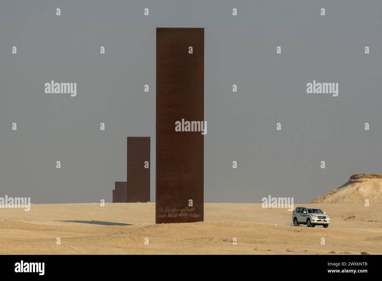 Brouq, Qatar. 28 mars 2024. La photo du dossier datée du 19 novembre 2021 montre la sculpture « East-West/West-East » de l’artiste américain Richard Serra, dans la réserve naturelle de Brouq au Qatar, à une heure de route à l’ouest de la capitale Doha. L’œuvre est composée de quatre plaques d’acier, chacune de plus de quatorze mètres de hauteur, au milieu du désert. Richard Serra vient de décéder, en mars 2024, à l’âge de 85 ans. Photo Balkis Press/ABACAPRESS.COM crédit : Abaca Press/Alamy Live News Banque D'Images