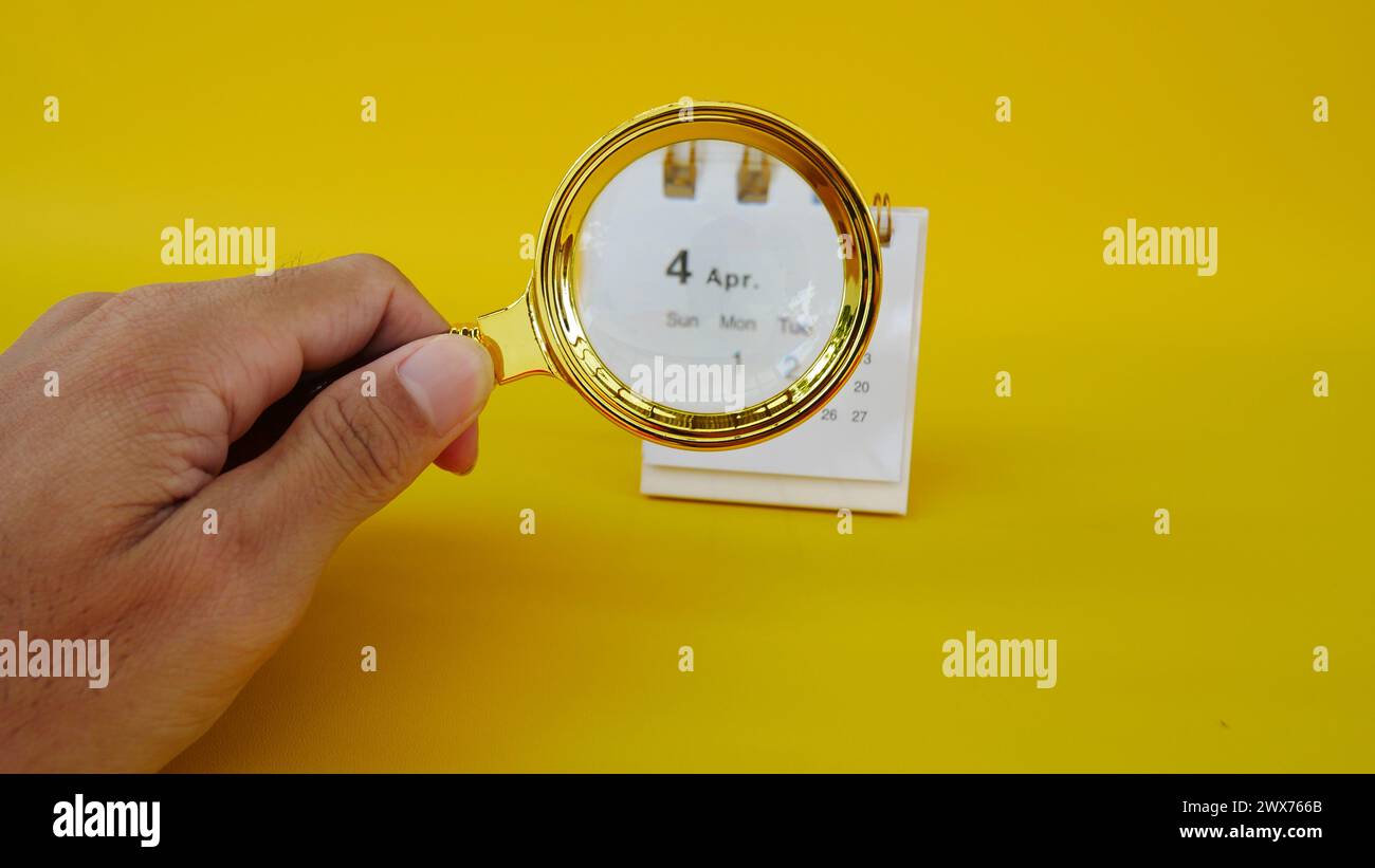 Calendrier d'avril 2024 à l'intérieur d'une loupe. Banque D'Images