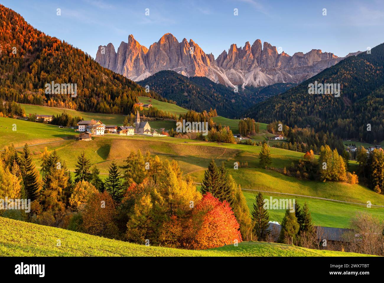 Une photo de coucher de soleil du village de Santa Magdalena avec son église dans le Val di Funes dans la région des Dolomites en Italie Banque D'Images