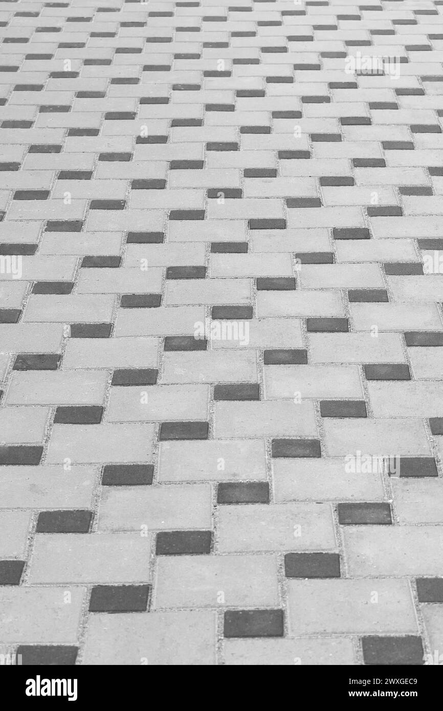 Structure abstraite de motif de pavage abstrait de surface de carrelage de sol sombre et gris en pierre de surface. Banque D'Images