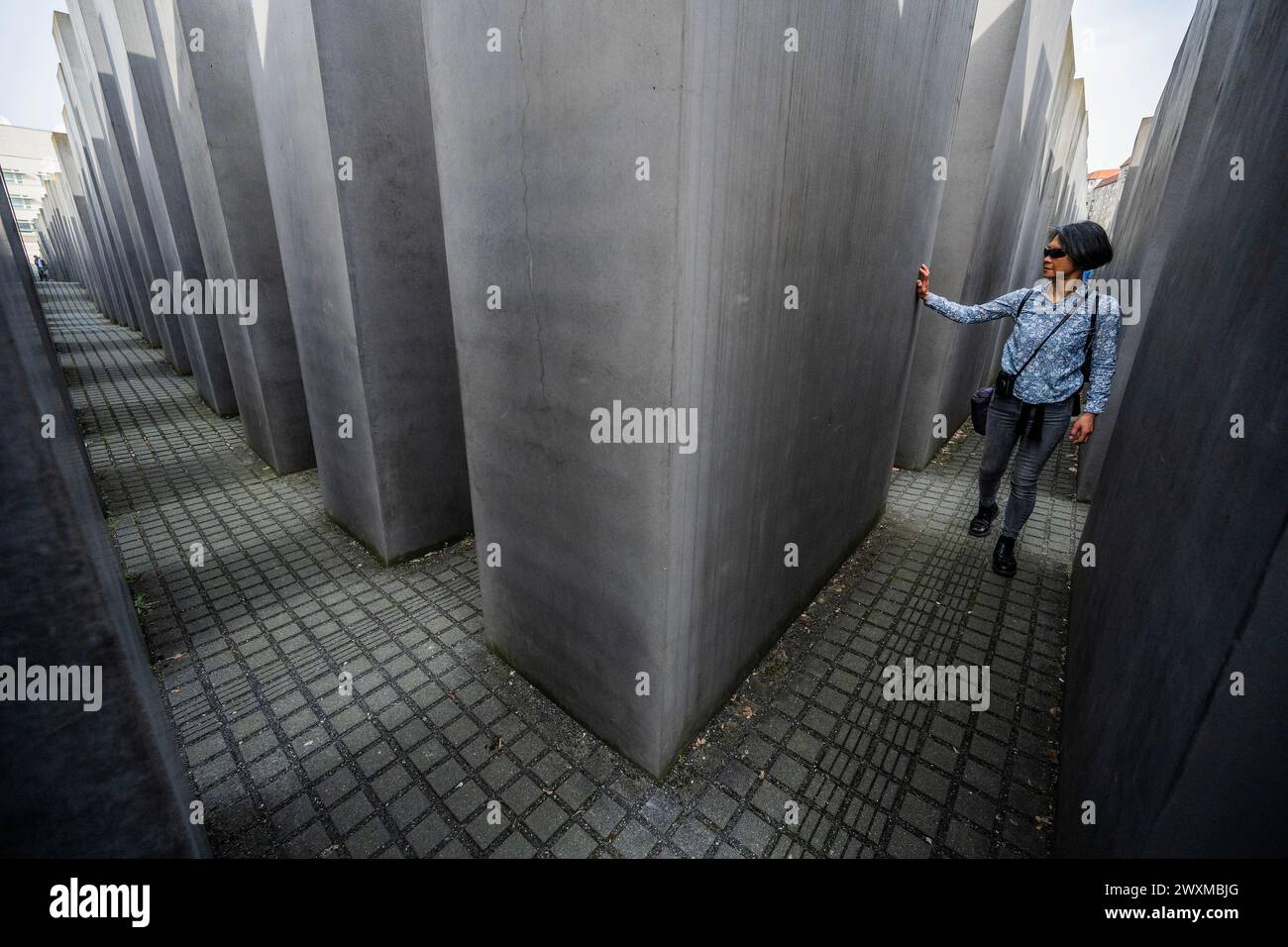 Berlin, Allemagne. 31 mars 2024. Printemps alors que les gens apprécient ou contemplent le mémorial - le Mémorial aux Juifs assassinés d'Europe au milieu de Berlin est le mémorial central de l'Holocauste en Allemagne, un lieu de commémoration et de commémoration pour les six millions de victimes juives de l'Holocauste. Il a été officiellement inauguré le 10 mai 2005. Le monument se compose du champ de stèles (2710 sculptures en béton) conçu par Peter Eisenman. Crédit : Guy Bell/Alamy Live News Banque D'Images