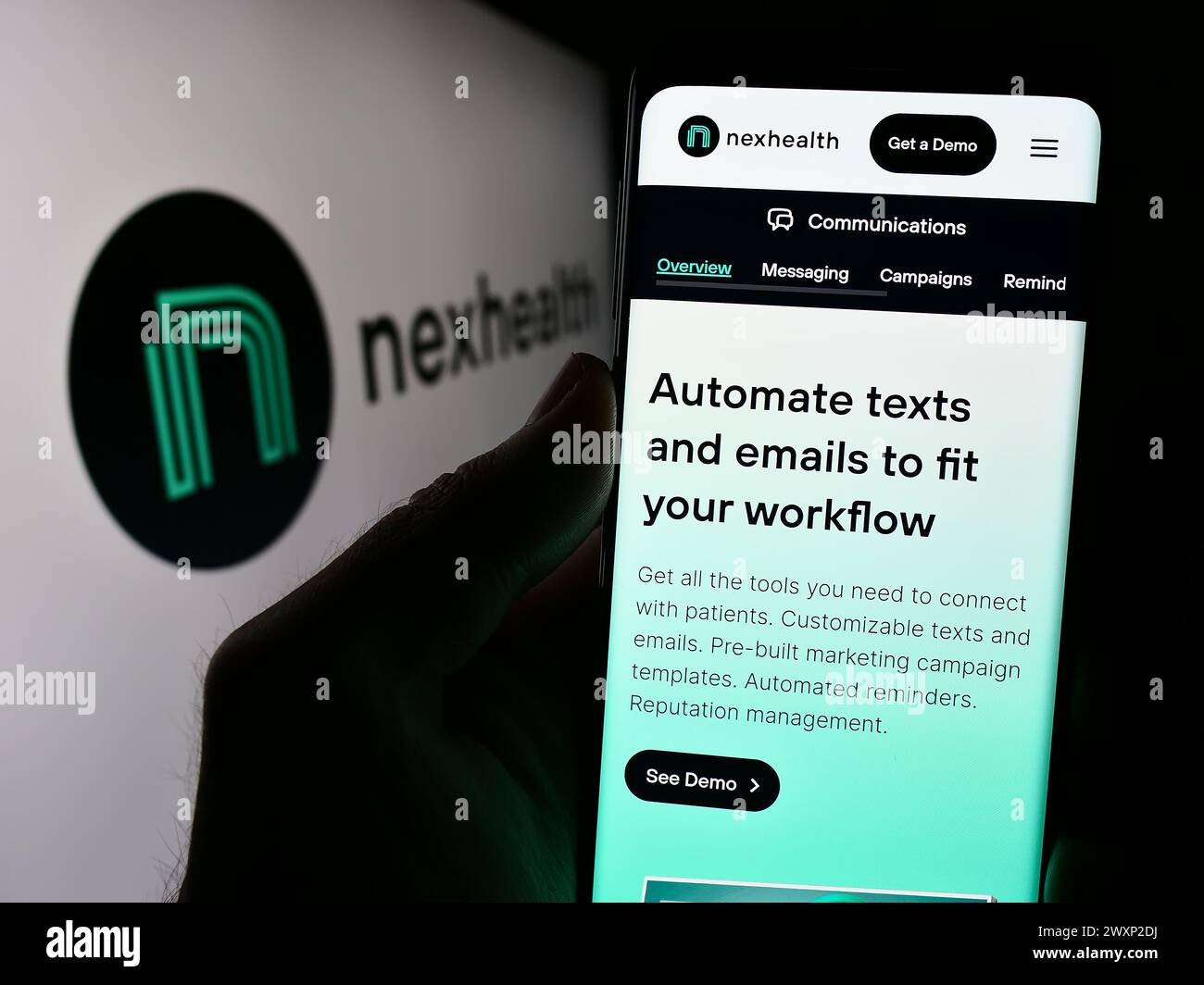 Personne tenant un smartphone avec la page Web de la société américaine de logiciels de soins de santé NexHealth Inc devant le logo. Concentrez-vous sur le centre de l'écran du téléphone. Banque D'Images