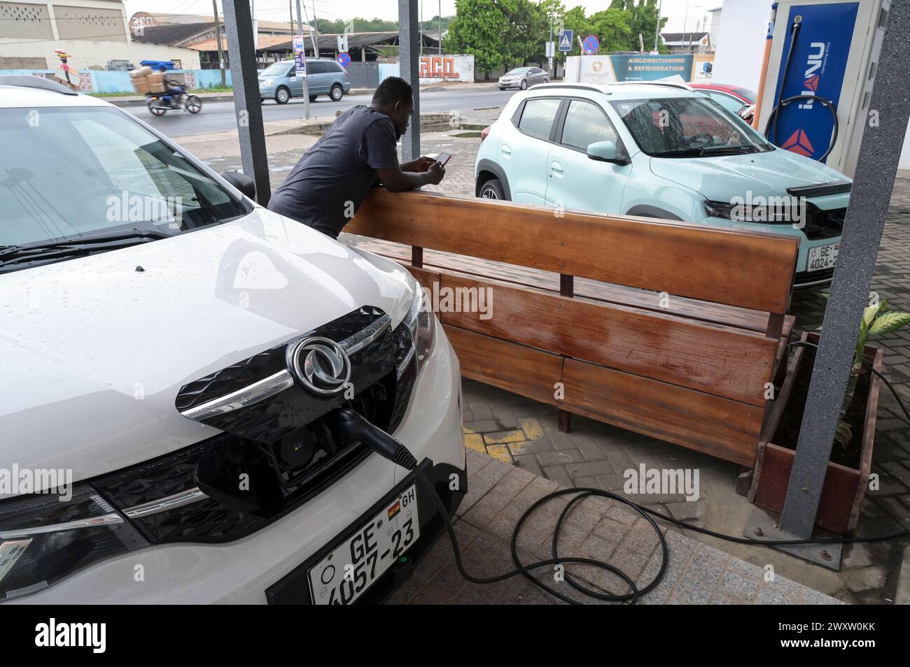 GHANA, Accra, mobilité électrique, service IJANU et station de recharge rapide pour voitures électriques, recharge de la voiture électrique chinoise Dongfeng EX1 / GHANA, Accra, E-Mobilität, IJANU Service und Ladestation für E-Autos, zwei chinesische Dongfeng EX1 E-Autos weiss und hellgruen Banque D'Images