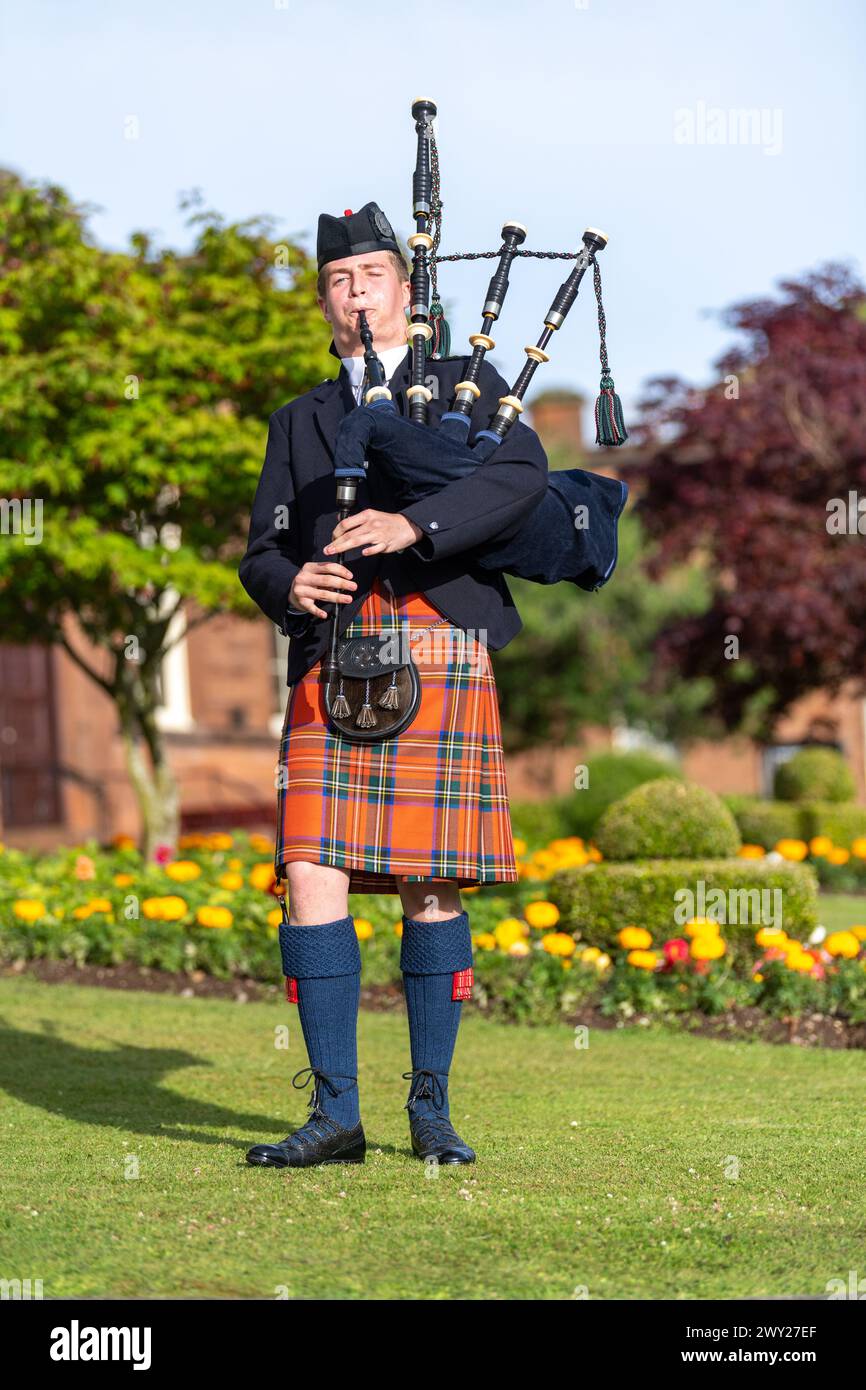 Homme écossais en tartan de clan, jouant de la cornemuse, un instrument de musique écossais traditionnel. Dumfries, Écosse. Banque D'Images