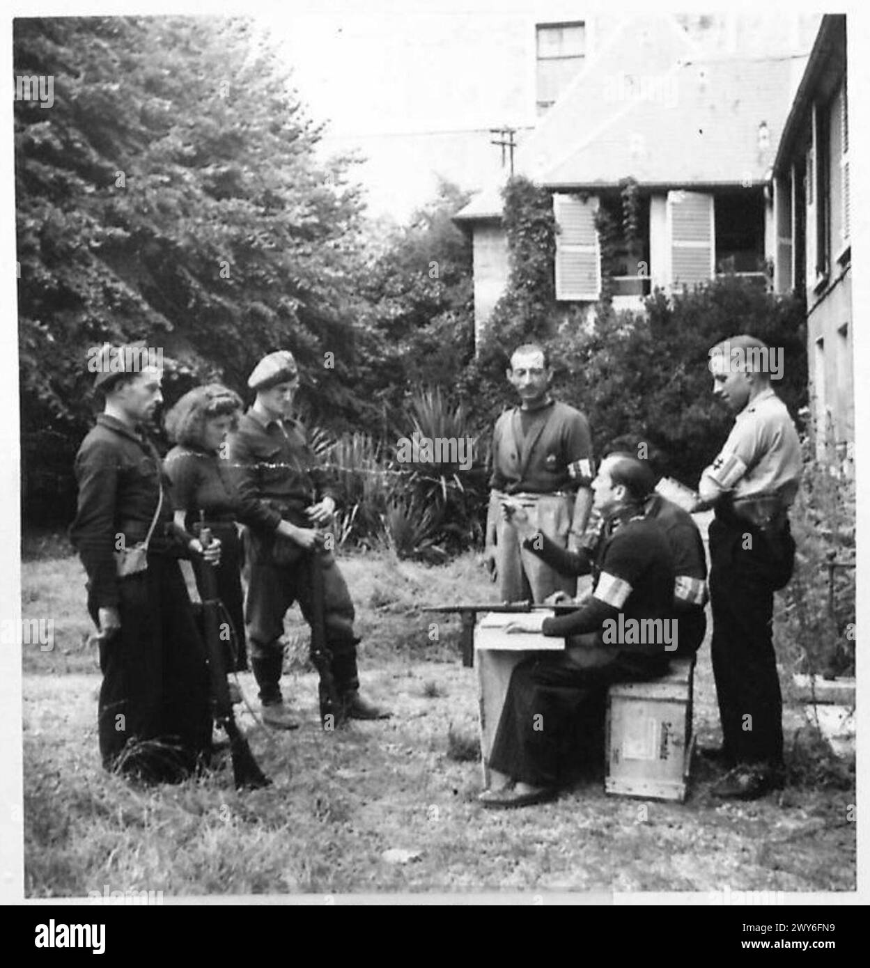 Une femme accusée de collaboration est interrogée par des responsables de FFI à Vernon au sujet de la fourniture d'informations à des officiers SS de l'armée britannique, 21e groupe d'armées. Banque D'Images