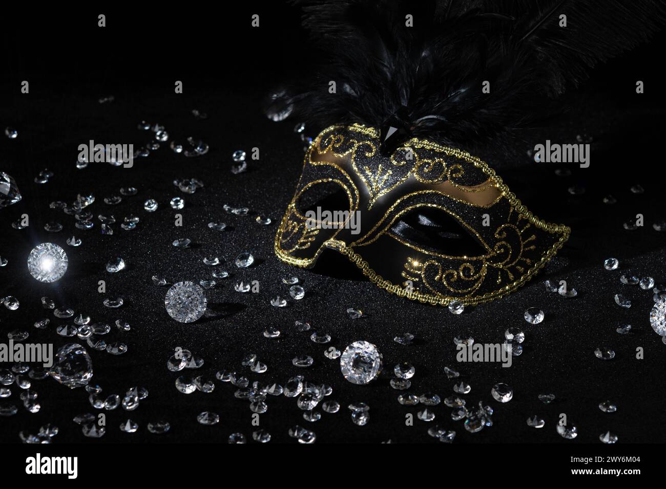 Masque d'or masqué avec des pierres précieuses sur fond noir. Banque D'Images