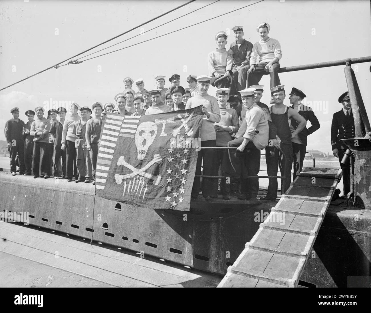 HM SUBMARINE SAFARI MAISON APRÈS 18 MOIS DE GUERRE MÉDITERRANÉENNE. 8 SEPTEMBRE 1943, FORT BLOCKHOUSE PORTSMOUTH. - Un phare, représentant une opération spéciale, est le dernier ajout à Jolly Roger de SAFARI exposé par les membres de son équipage. , Banque D'Images