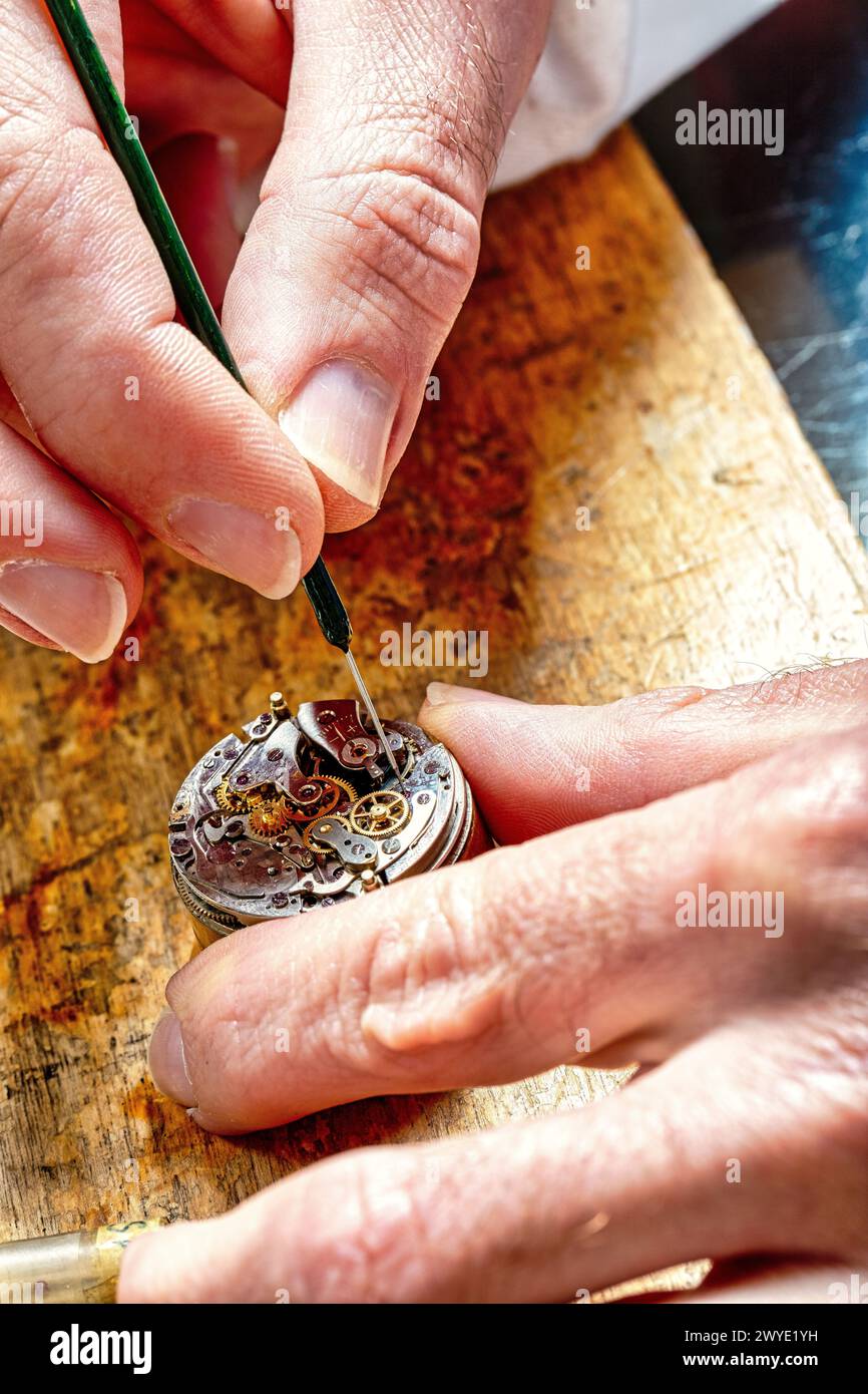 maître au travail, manœuvrant délicatement à travers la danse complexe de l'assemblage de montres Banque D'Images