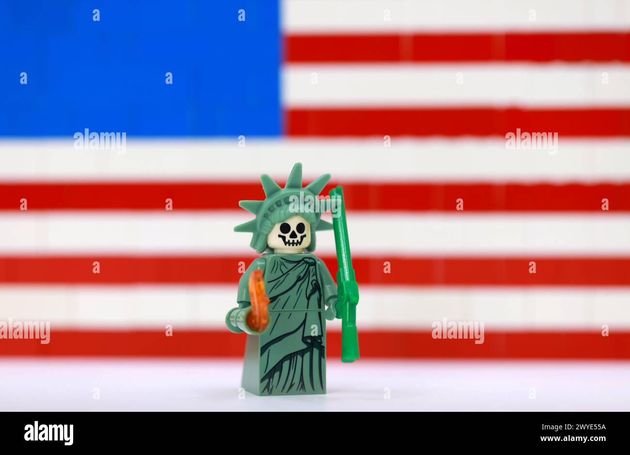 La robe citoyenne comme Statue de la liberté avec le masque de crâne tient le dollar sous le drapeau américain. Banque D'Images