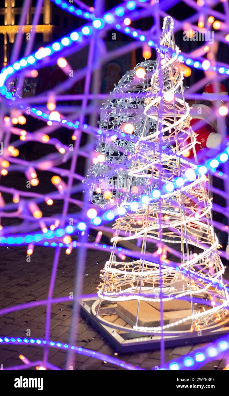 Sapins de Noël illuminés. Lumières brillantes des fêtes Banque D'Images