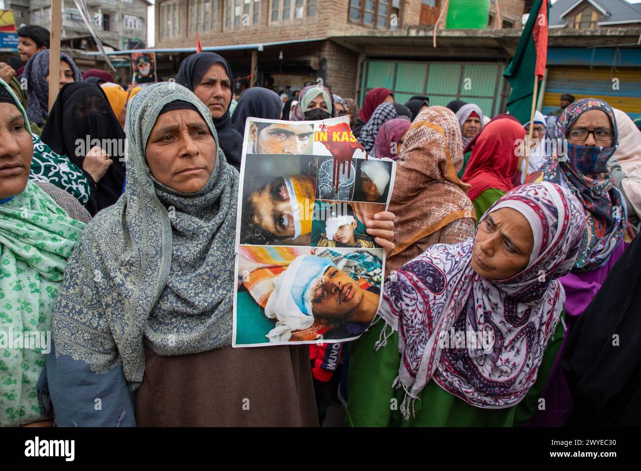 Srinagar, Inde. 05th Apr, 2024. Une femme musulmane tient une pancarte montrant des photos de victimes de fusils à granulés cachemiris lors d'une manifestation contre Israël et l'Amérique lors d'une manifestation contre les opérations militaires israéliennes à Gaza. Des dizaines de musulmans du Cachemire portaient des pancartes et des drapeaux palestiniens lors d'un rassemblement dans le Magam du centre du Cachemire, à environ 25 km de Srinagar, commémorant la Journée Al Qods (Jérusalem). La Journée Al Qods est célébrée le dernier vendredi (Jumat-ul-Vida) du mois Saint du Ramadan pour exprimer notre solidarité et notre soutien aux Palestiniens. Crédit : SOPA images Limited/Alamy Live News Banque D'Images