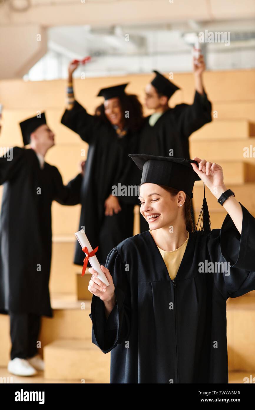 Un groupe diversifié d'étudiants en robes de graduation et mortarboards célébrant leur réussite scolaire. Banque D'Images