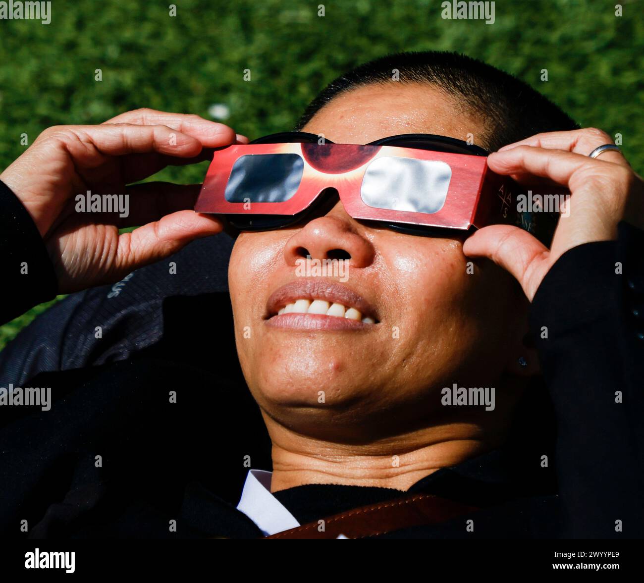 Milwaukee, États-Unis. 08 avril 2024. Une femme regarde à travers des lunettes solaires spéciales tandis que la lune se déplace sur le soleil pendant l'éclipse solaire de 2024 à Milwaukee, Wisconsin, le lundi 8 avril 2024. La dernière éclipse en Amérique du Nord remonte à 2017 et la prochaine sera en 2044. Photo de Tannen Maury/UPI crédit : UPI/Alamy Live News Banque D'Images