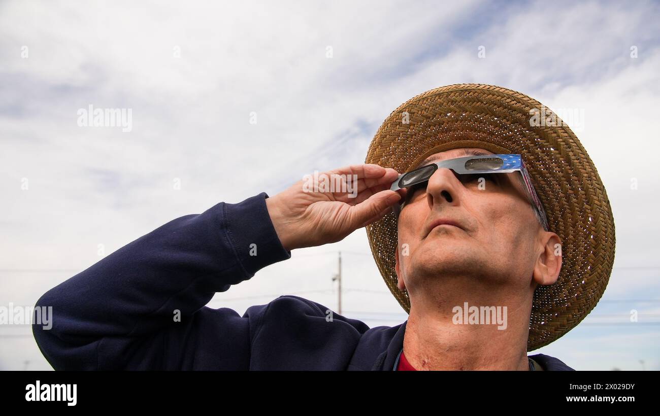NORWALK, CT, USA - 8 AVRIL 2024 : L'homme regarde l'éclipse américaine avec des lunettes de protection Banque D'Images