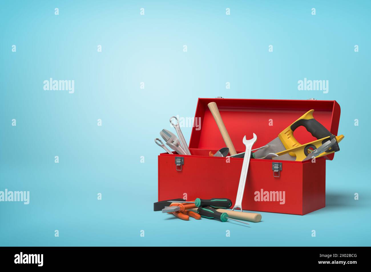 Boîte à outils partiellement remplie avec des outils sur bleu Banque D'Images