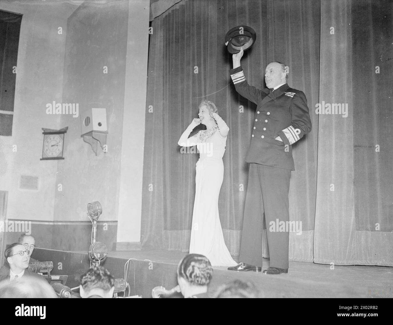 C IN C ROSYTH OUVRE LA NOUVELLE ROYAL NAVY ET LA ROYAL MARINE CANTEEN. 1941, MLLE EVELYN LAYE, PRÉSIDENTE RNENSA, A DONNÉ UN SPECTACLE ASSISTÉ PAR MLLE BEATRICE LILLIE ET COMPAGNIE. - Le C en C donne trois acclamations pour Mlle Evelyn Laye Banque D'Images