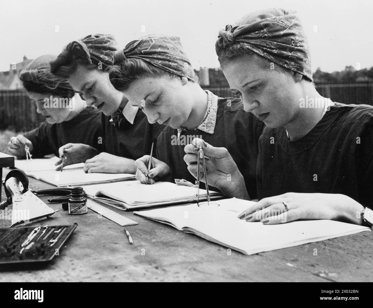 Entre 1939 et 1945, les stagiaires de l'industrie de guerre britannique dans une usine de munitions du gouvernement pratiquaient le dessin de plan à l'aide de rapporteurs, dans le cadre des programmes de formation élargis du ministère du travail pendant la première Guerre mondiale Banque D'Images