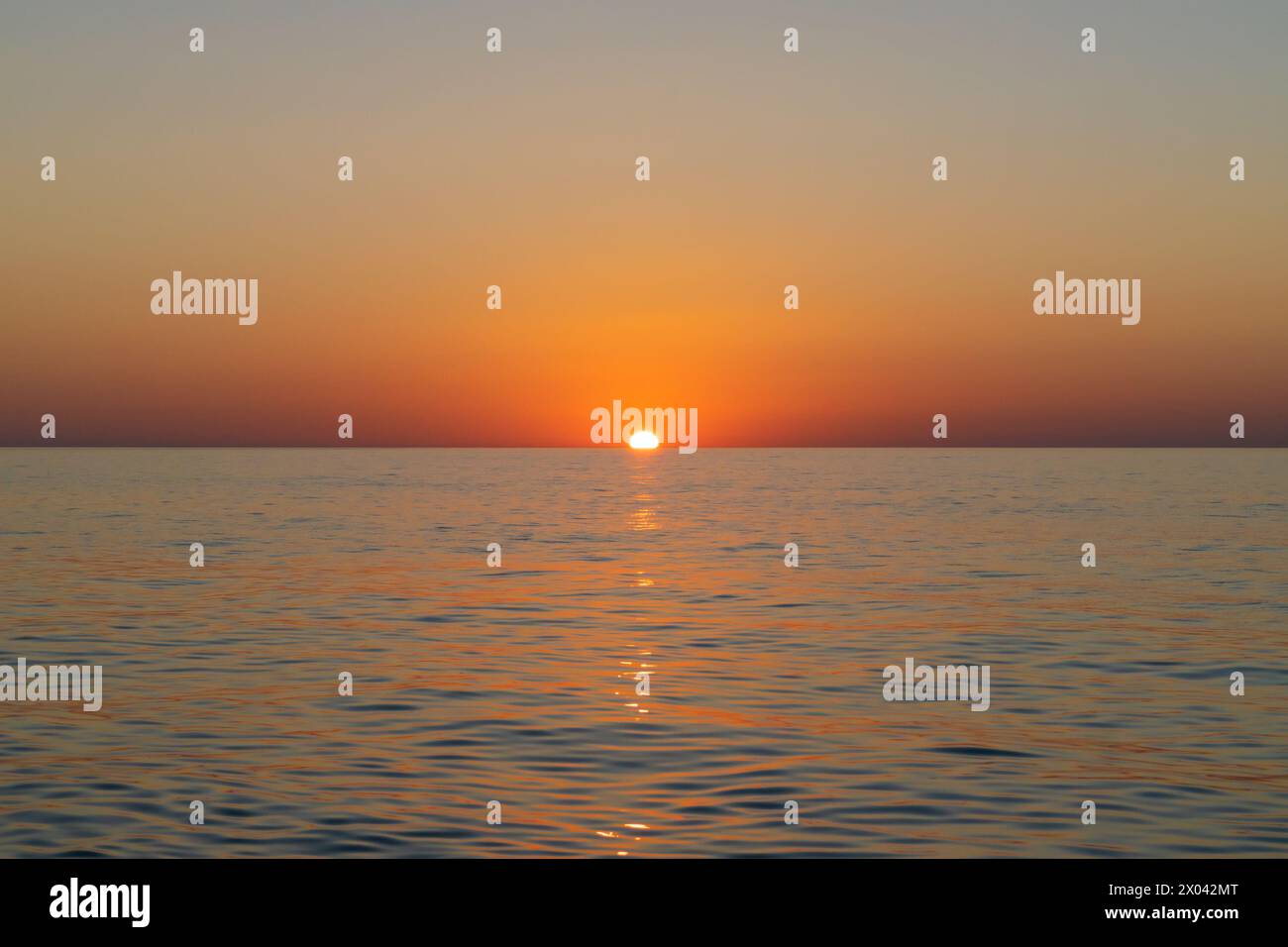 Beau coucher de soleil sur la mer. Le soleil se couche sous l'horizon. Seascape. Banque D'Images