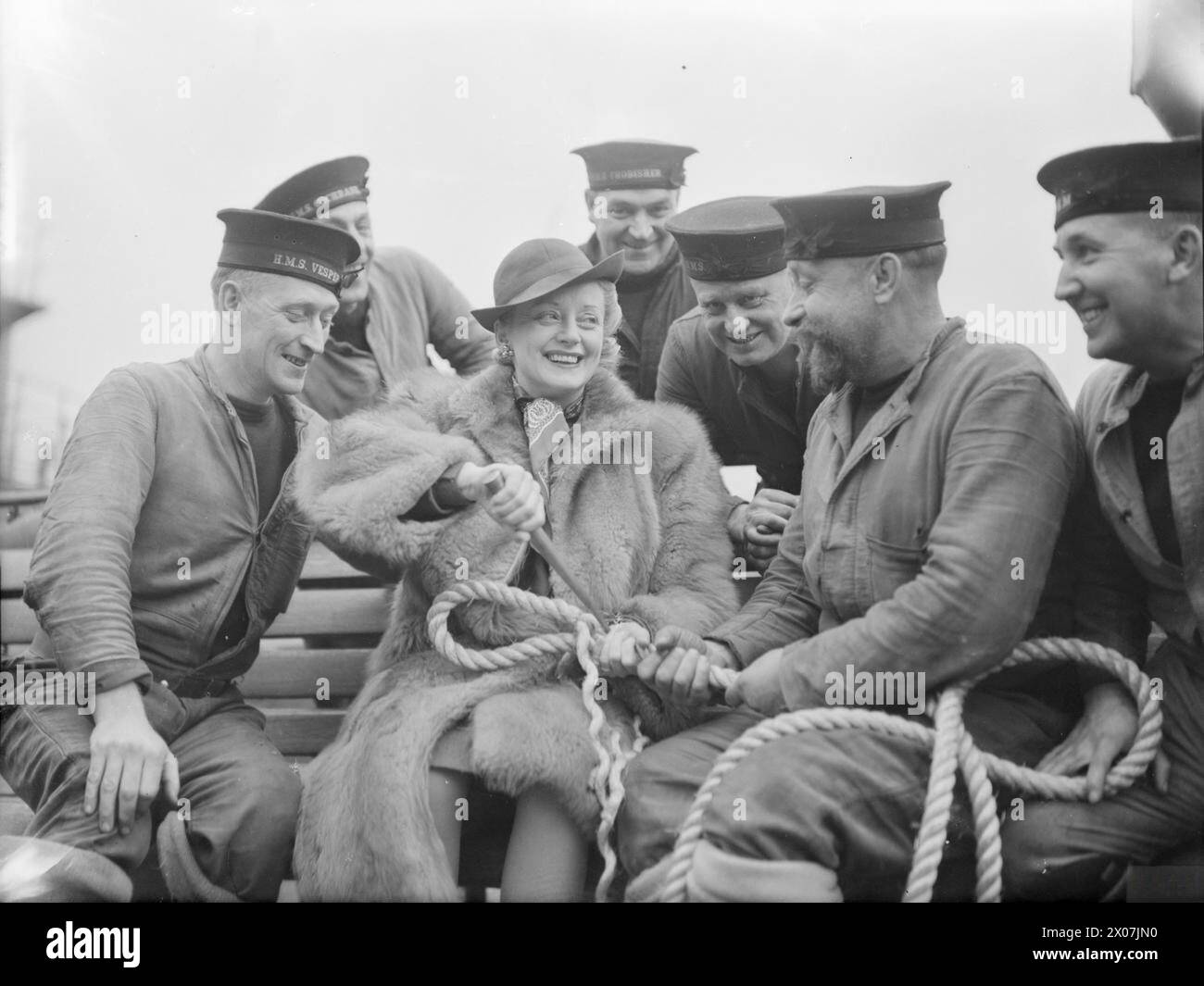 Evelyn Laye est photographiée en train de pratiquer l'épissure de corde lors de sa visite dans un port naval en 1941, démontrant des compétences de base en marine. Banque D'Images
