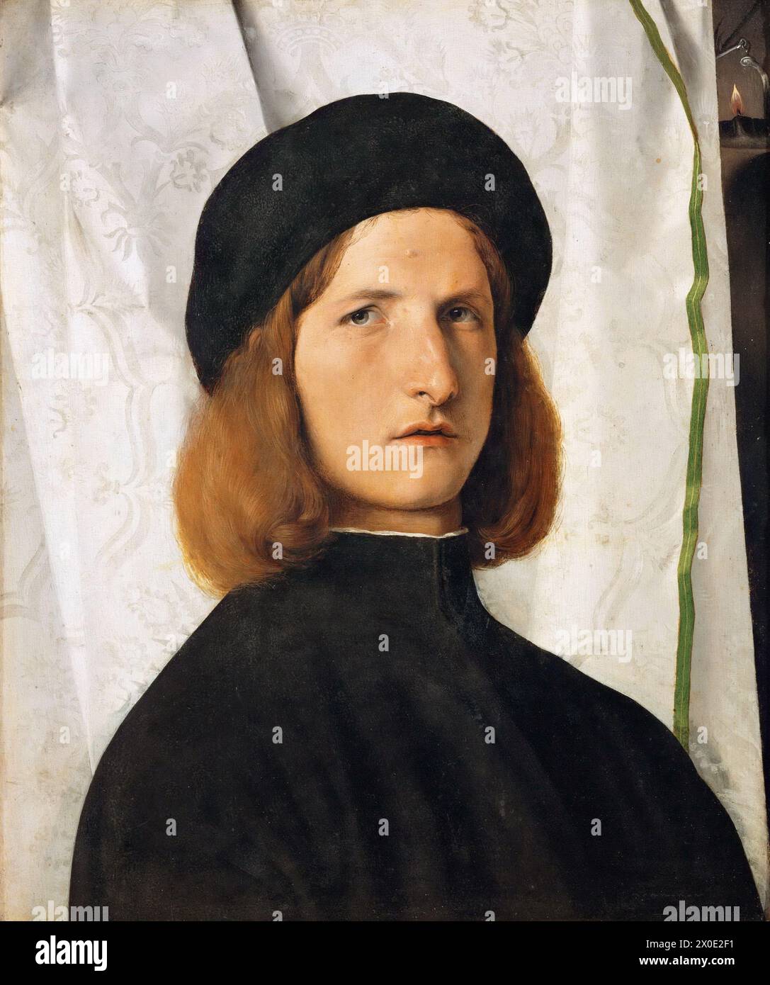 Le Portrait d'un jeune homme avec une lampe est une peinture à l'huile sur toile du peintre italien de la haute Renaissance Lorenzo Lotto, datant de vers 1506. Banque D'Images