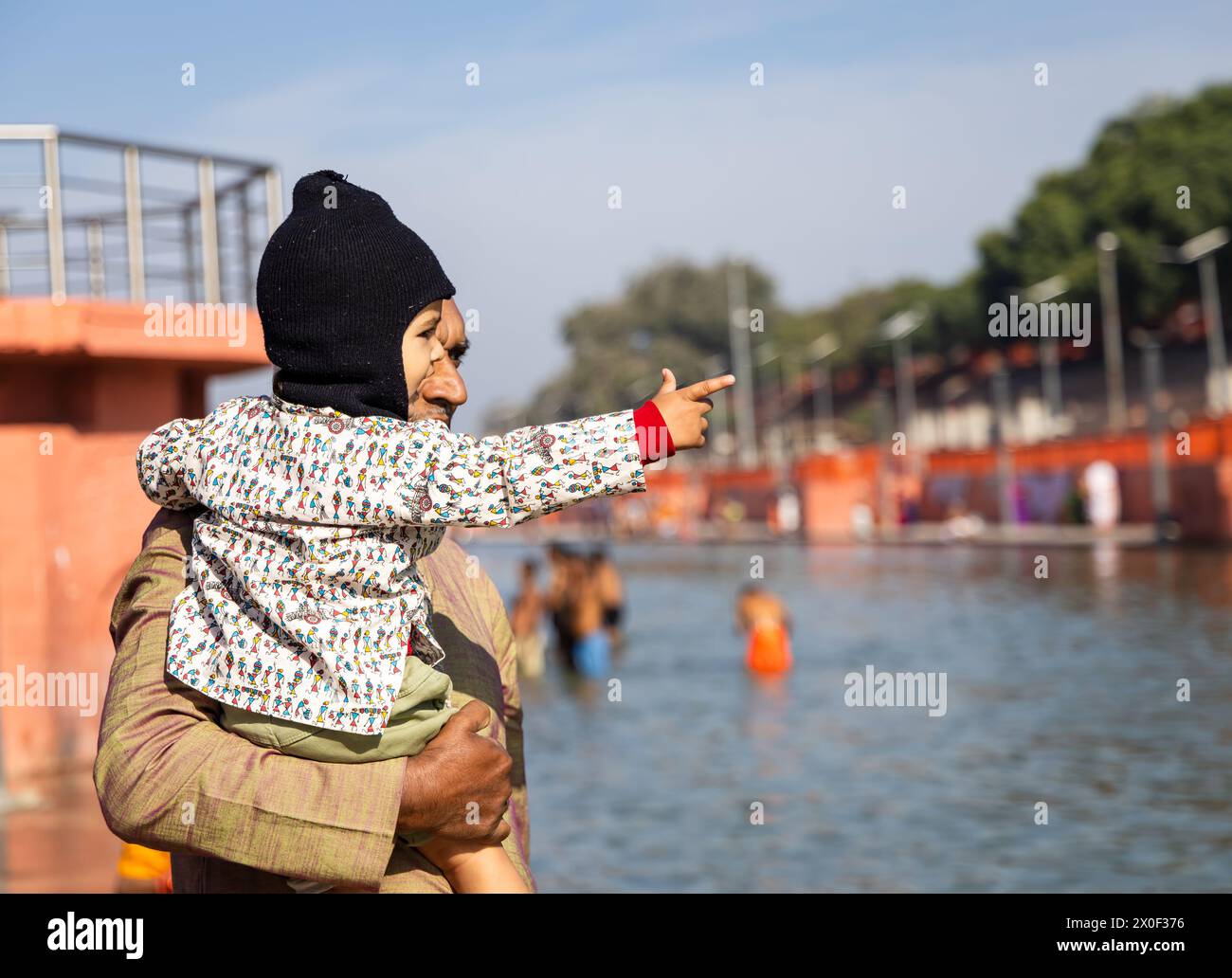enfant en bas âge innocent et grand-père debout près de la rivière sacrée le matin à partir d'un angle plat Banque D'Images