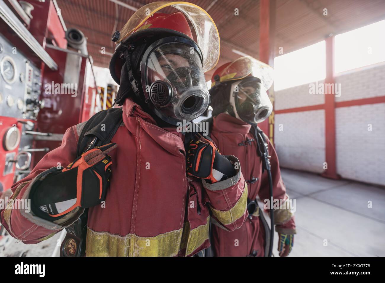 Pompier féminin avec des vêtements de travail travaillant à la caserne de pompiers Banque D'Images