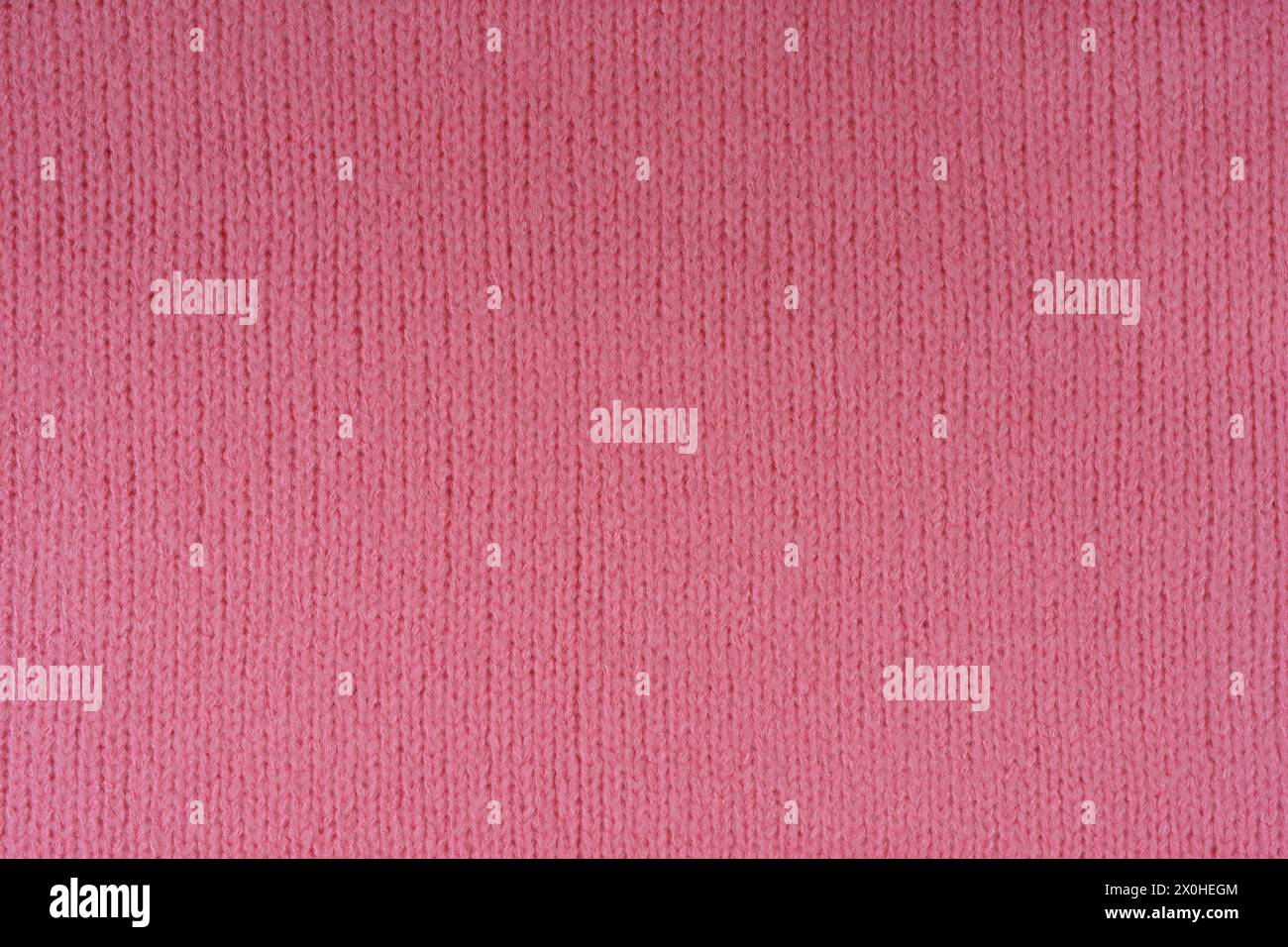 Tissu en jersey de laine tricoté rose, pull, fond de texture de pull. Toile de fond abstraite, papier peint en tissu Banque D'Images