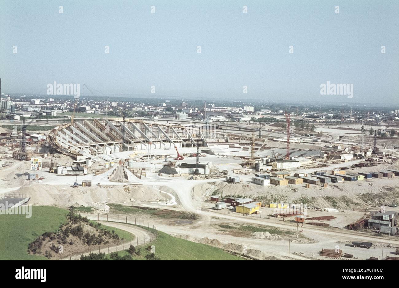 Vue depuis la montagne de gravats jusqu’au chantier du stade Olympique, où les pièces préfabriquées viennent d’être posées sur les supports en béton. [traduction automatique] Banque D'Images