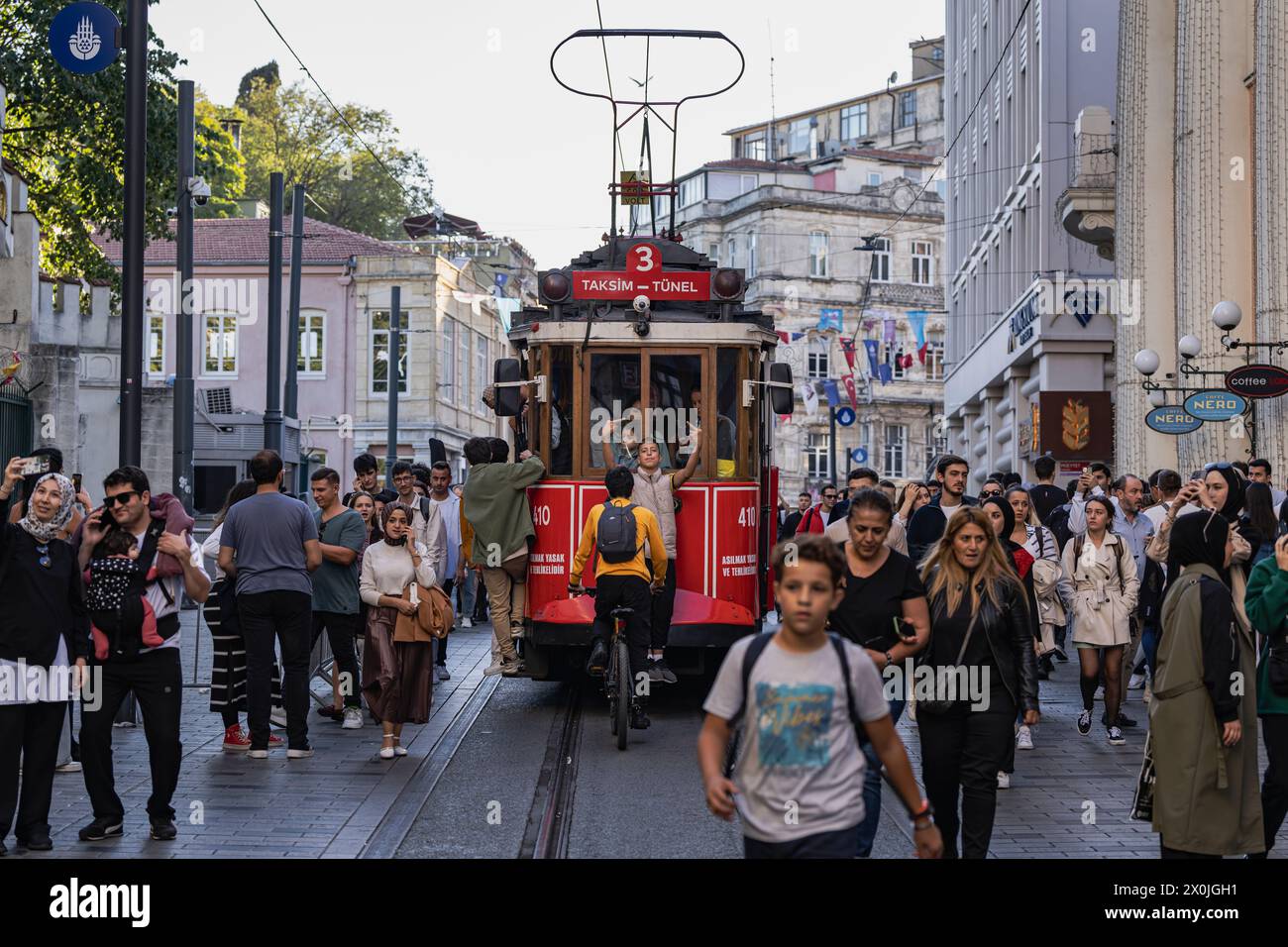 Jeunesse montrant le majeur, tramway historique, rue commerçante, Ä°stiklal, Istanbul Turquie, Europe Banque D'Images