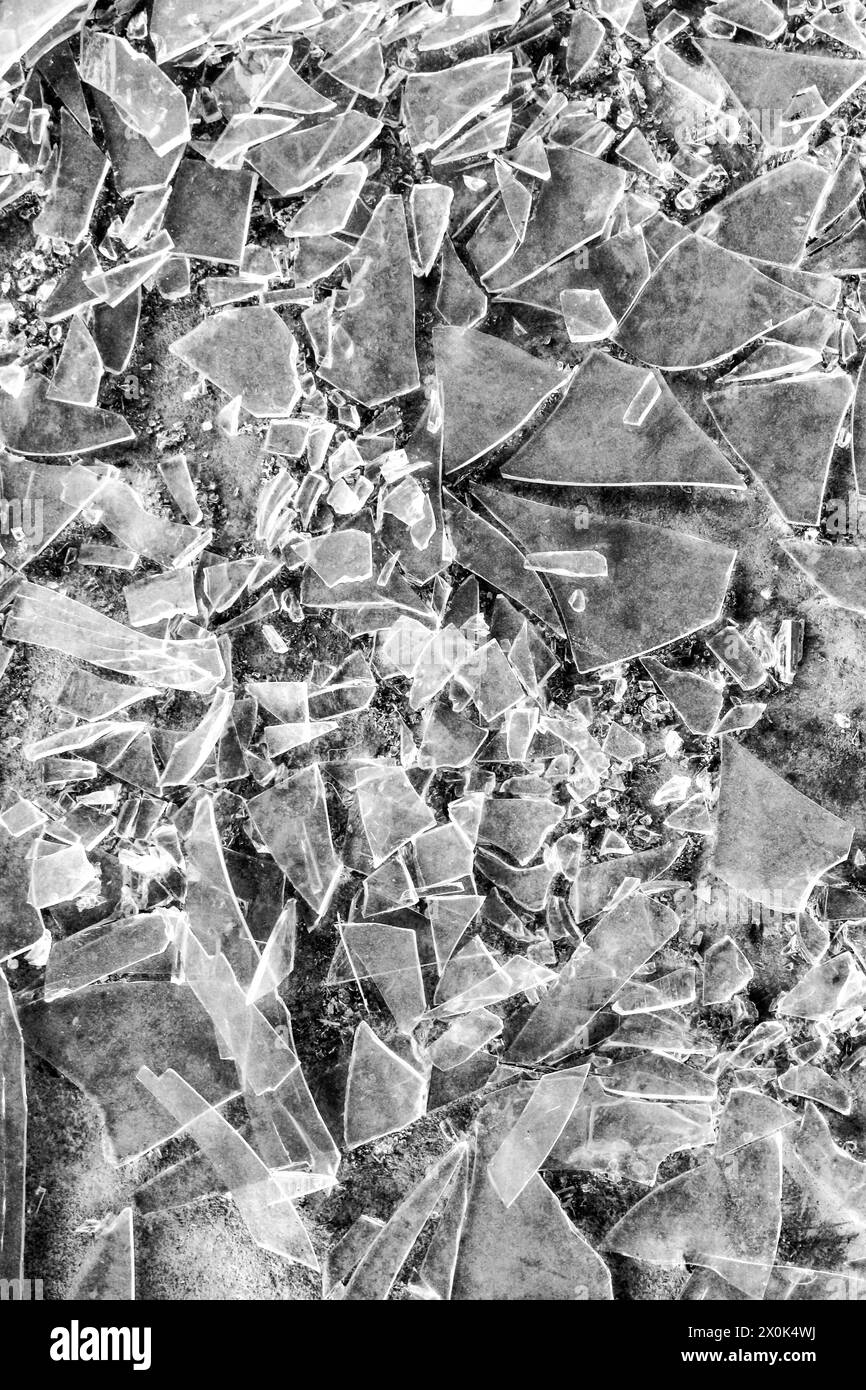 Plongez dans le monde fracturé du verre brisé avec cette texture fascinante, capturant les motifs complexes et les bords dentelés des vitres fragmentées Banque D'Images
