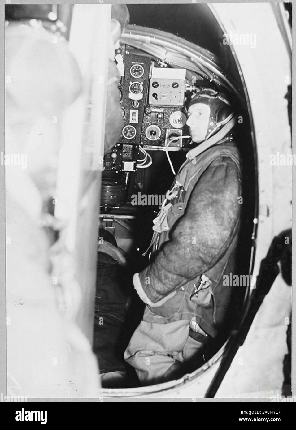 BOMBARDIERS DE NUIT DE LA ROYAL AIR FORCE - tous habillés - et quelque part où aller! Deuxième pilote d'un bombardier de nuit à son poste. Négatif photographique, Royal Air Force Banque D'Images