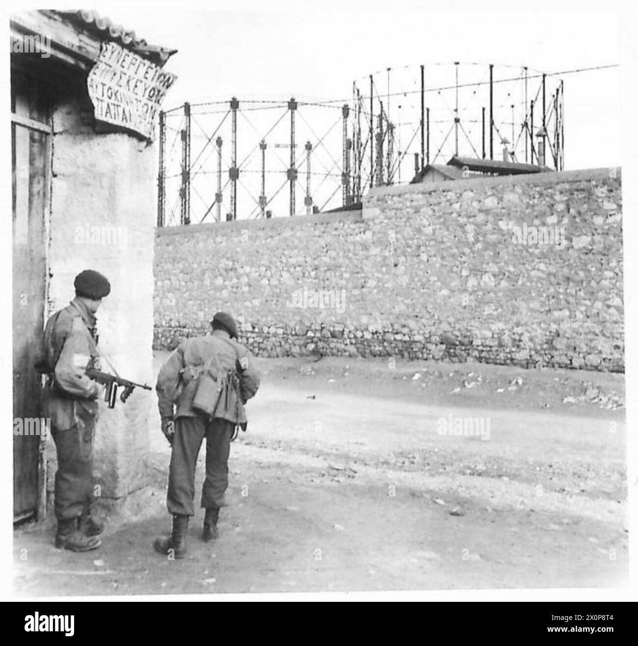 Les parachutistes britanniques à Athènes approchent d'une usine à gaz qui était inactive depuis l'occupation de l'E.L.A.S. et observent prudemment la zone lors de leur avance la veille de Noël. Banque D'Images