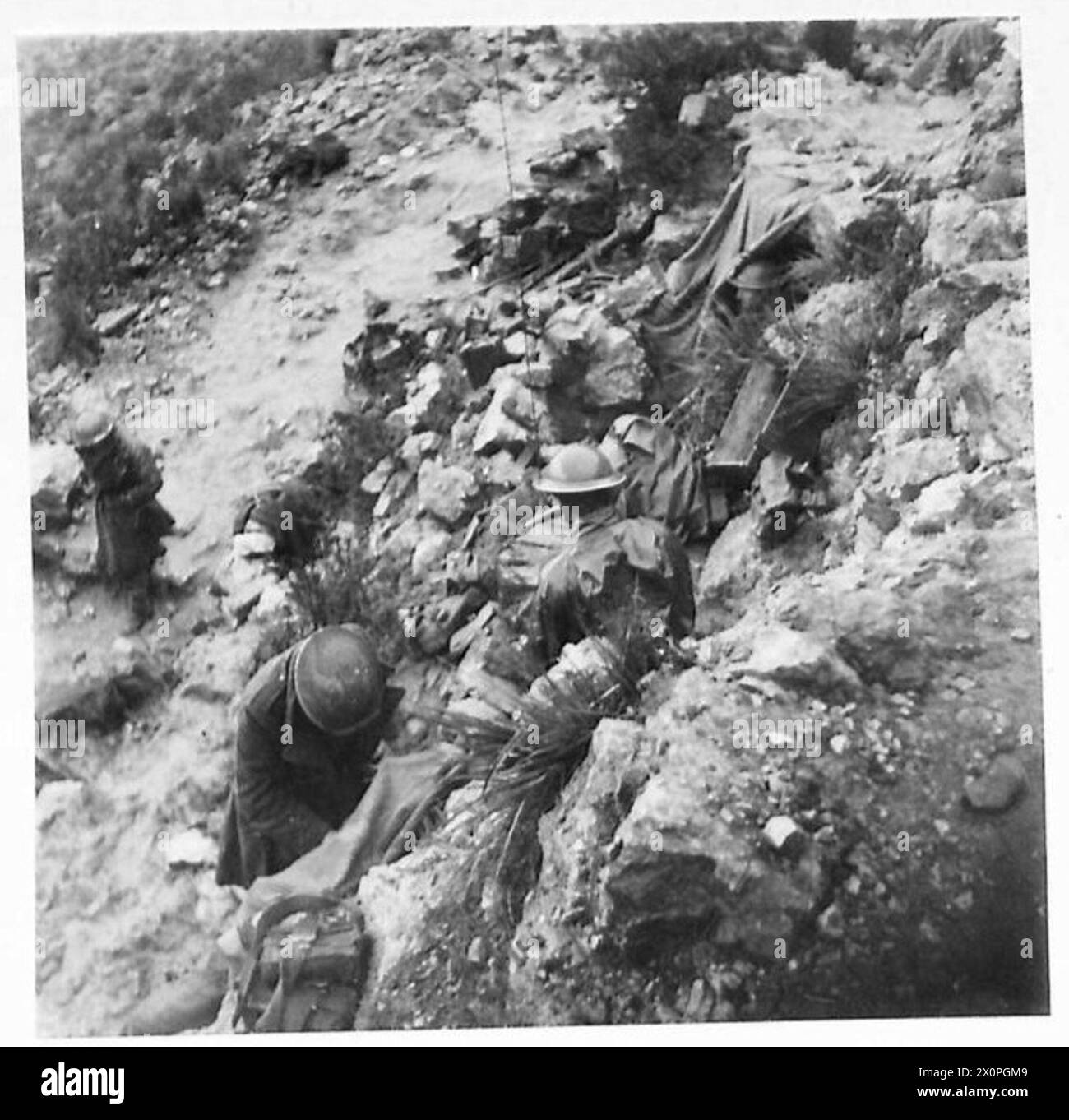 Troupes alliées de la 5e armée lors de l'assaut sur le mont Camino en Italie. Les soldats des London Irish Rifles s'abritent des conditions météorologiques défavorables au sommet de la montagne. Une mitrailleuse du régiment du Cheshire est positionnée au sommet. La photographie capture le terrain difficile et les conditions auxquelles les troupes sont confrontées. Négatif photographique, armée britannique. Banque D'Images