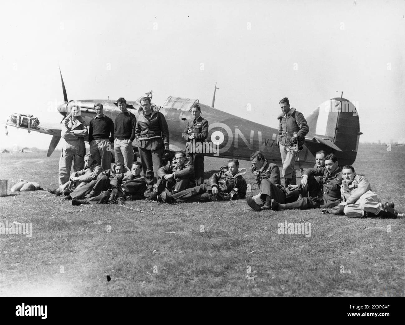 OPÉRATIONS DE LA ROYAL AIR FORCE AU-DESSUS DE L'ALBANIE ET DE LA GRÈCE, 1940-1941. - Pilotes du No. 33 Squadron RAF, à Larissa, Grèce, avec Hawker Hurricane Mark I, V7419, en arrière-plan. Debout (de gauche à droite) ; officiers pilotes W Winsland, R Dunscombe (mort le 22 mai 41), C A C Chetham (k.i.a. le 15 avril 41), et P R W Wickham, officiers volants d T Moir et H J Starrett (mort de brûlures le 22 avril 41) : assis (de gauche à droite); officier de vol E J 'Timber' Woods (k.i.a. 17 juin 41), officier de vol F Holman (k.i.a. 20 mai 41), lieutenant de vol A M Young, officier de vol V C 'Woody' Woodward, chef d'escadron M St J 'Pat' Pat Banque D'Images