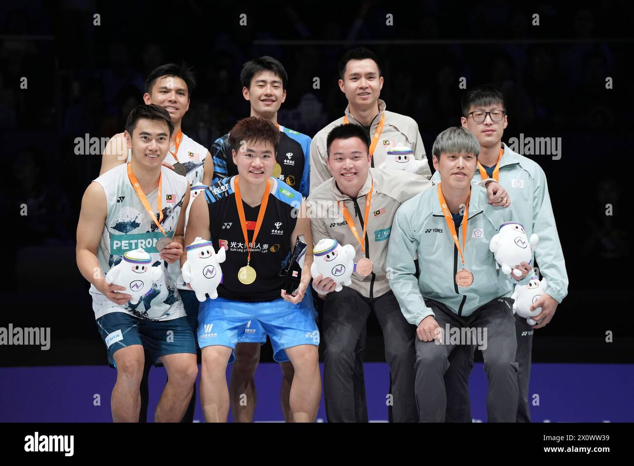 China's Wang Chang and Liang Wei Keng, second from left celebrate with their gold medals after defeating Malaysia's Goh Sze Fei and Nur Izzuddin, left as others pose with the bronze medals in the men's doubles final for the Bank of Ningbo Badminton Asia Championships 2024 in Ningbo, eastern China's Zhejiang province held on Sunday, April 14, 2024. (AP Photo) Banque D'Images