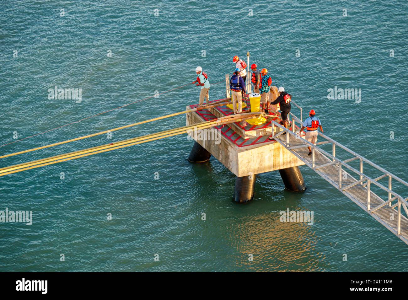 Harvest Caye Island Belize, navire Norwegian Joy Cruise Line, itinéraire de 7 jours de la mer des Caraïbes, privé privé, personnel d'amarrage, lignes d'amarrage épaisses Banque D'Images