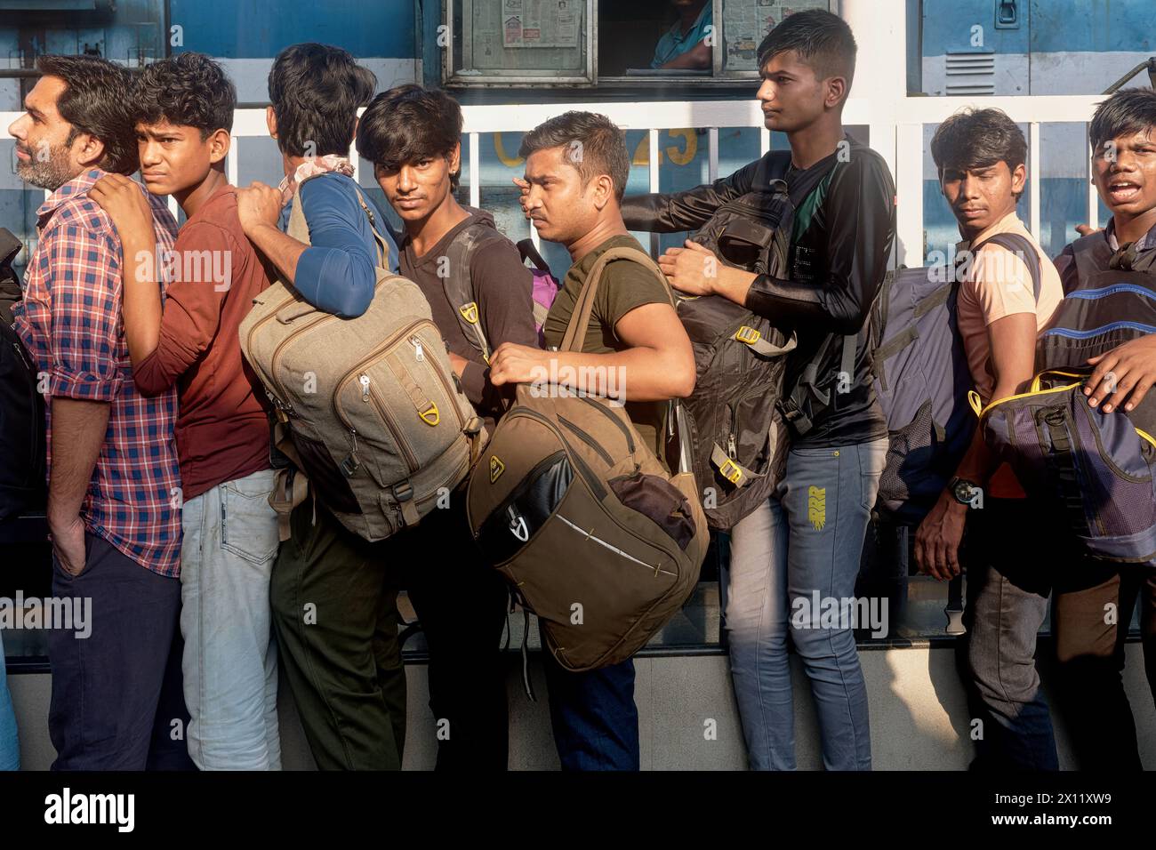 Travailleurs migrants de l'Uttar Pradesh dans le nord de l'Inde faisant la queue pour monter à bord d'un train pour leur État d'origine ; à Chhatrapati Shivaji Maharaj Terminus, Mumbai, Inde Banque D'Images