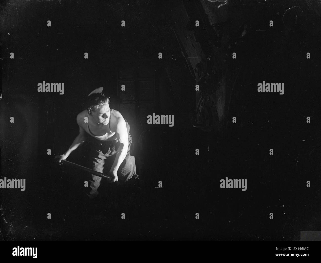 Le 31 février 1945, le HMS Rosemary, un sloop au charbon âgé de 30 ans, reste en service actif à Greenock, le Stoker Charlie Bailey alimentant ses incendies. Banque D'Images