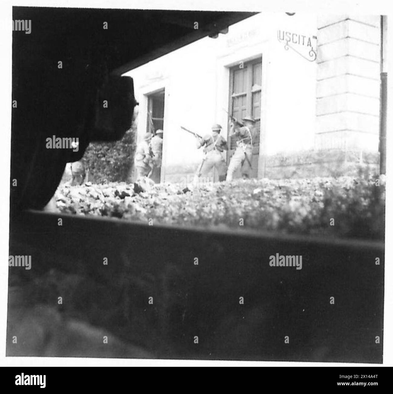 Les troupes de l'Armée du désert prennent d'assaut et sécurisent une gare sicilienne en utilisant la couverture d'un château d'eau et des camions de chemin de fer, s'adaptant aux nouveaux terrains et tactiques de combat. Banque D'Images